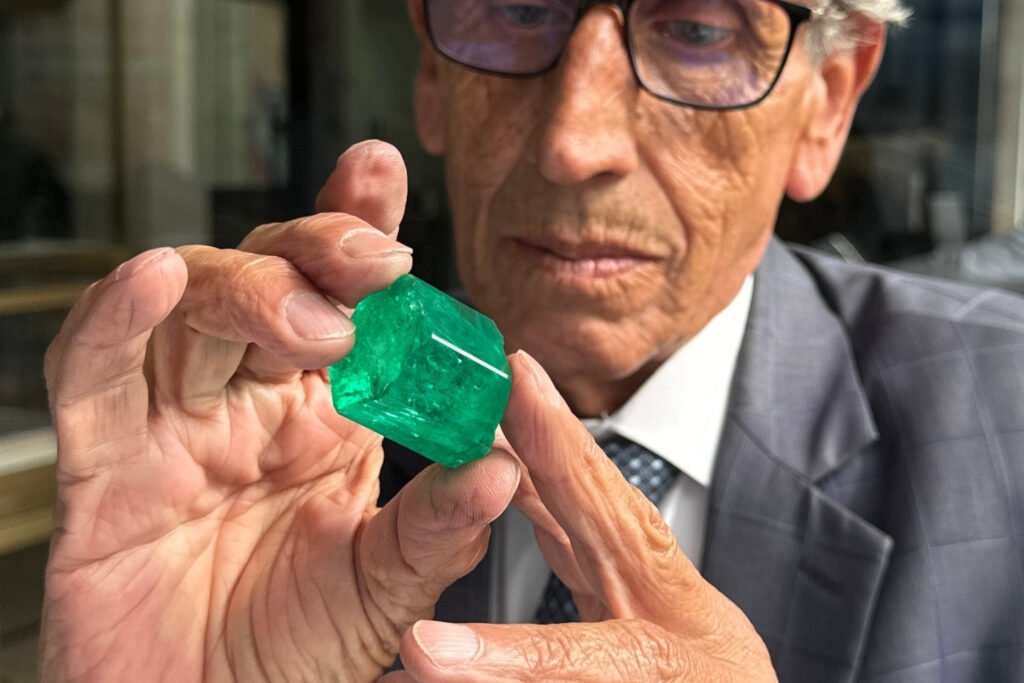 Master lapidary Ricardo Jimenez looks at a rough Colombian emerald