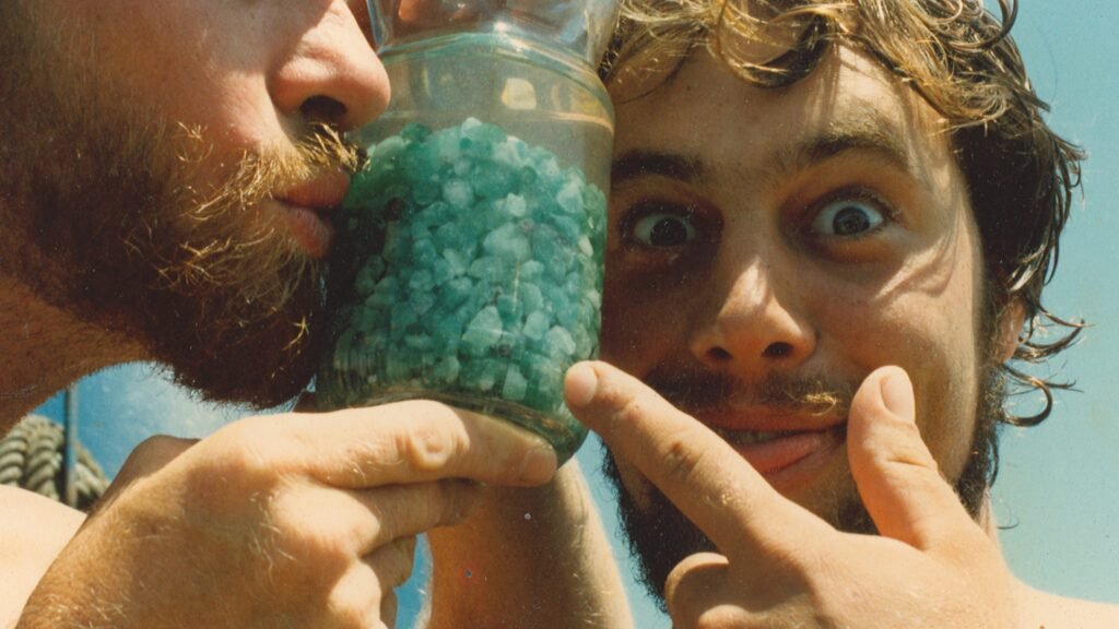 Mel Fisher's team posing with a jar full of emeralds