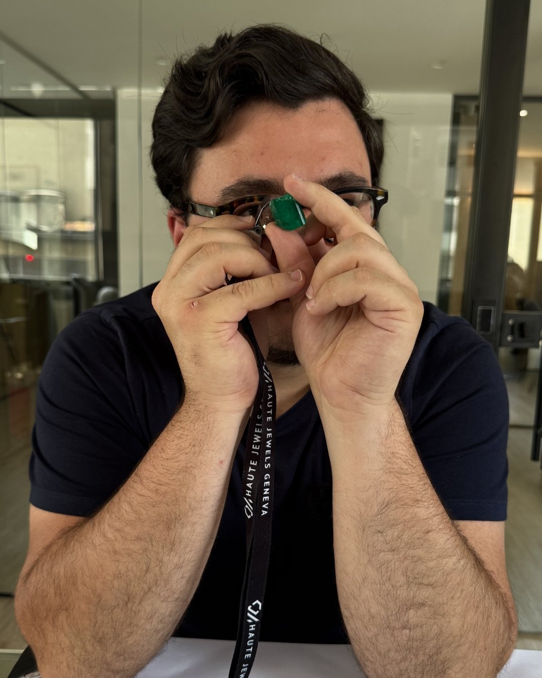 Guilhem Merolle, colombian emerald expert, looking at a rough colombian emerald from Muzo