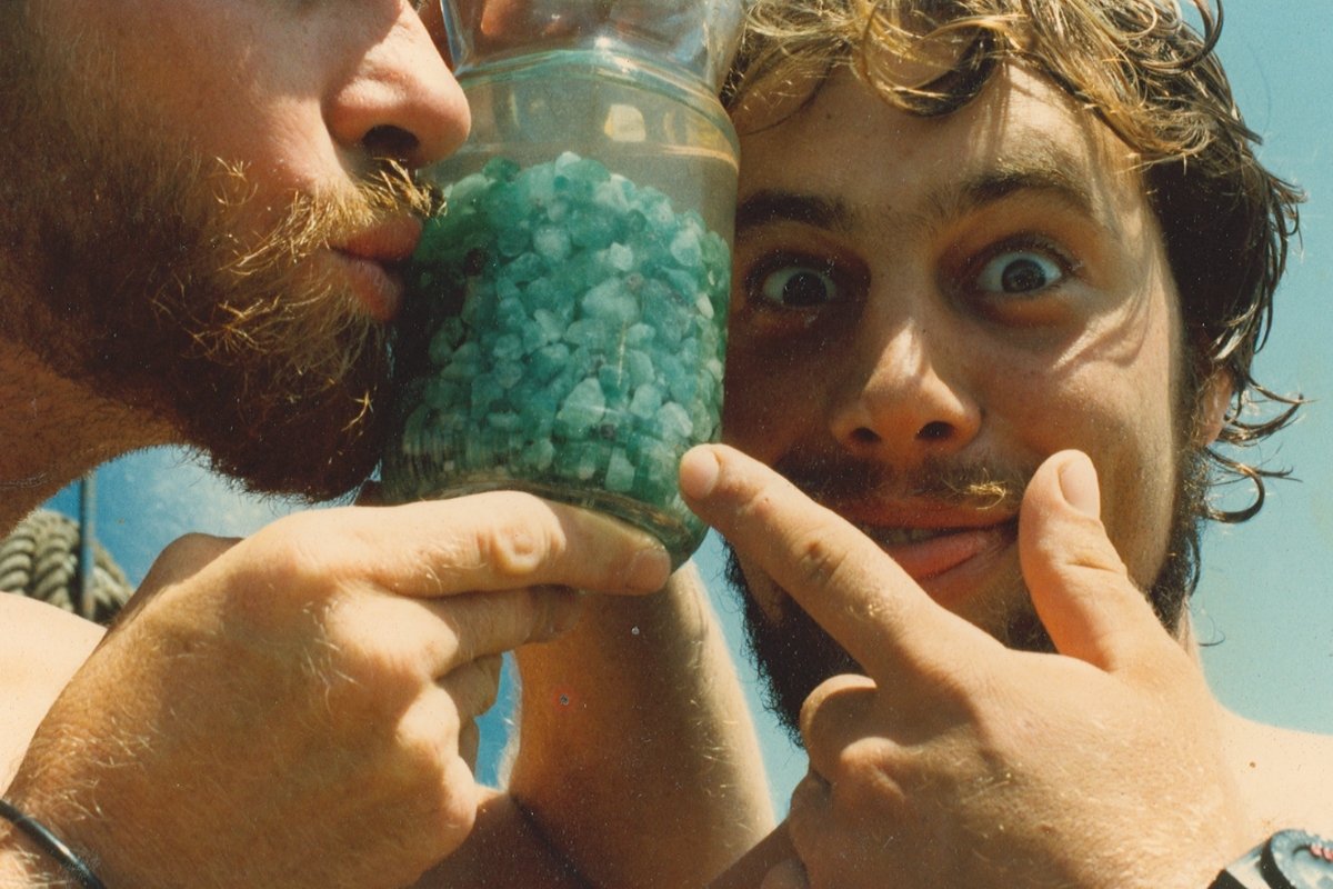 Mel Fisher's team posing with a jar full of emeralds